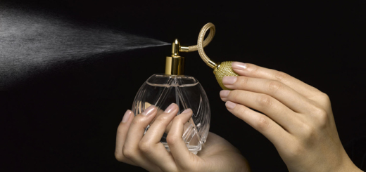 Woman spraying perfume with perfume atomizer, close-up of hands