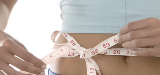 Woman Tying Measuring Tape Around Her Waist